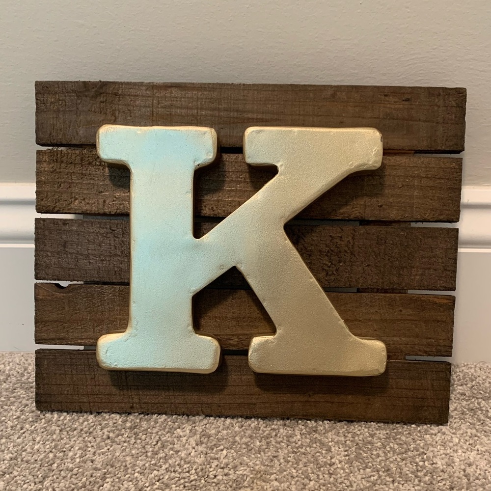 Brown wood and gold “K” wall/shelf art